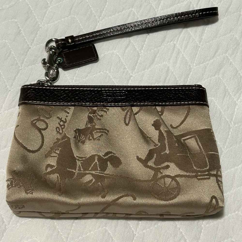 Gold Coach wristlet with pink interior
